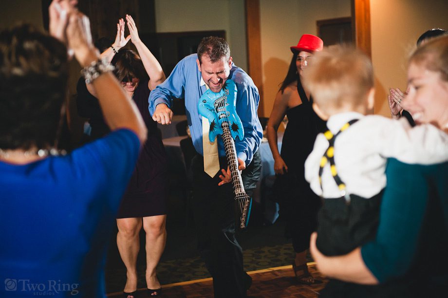Dancing during reception with inflatable guitar