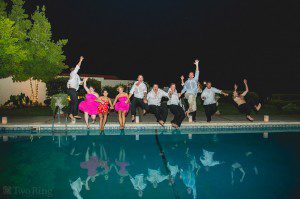 Bridal party jumping in pool