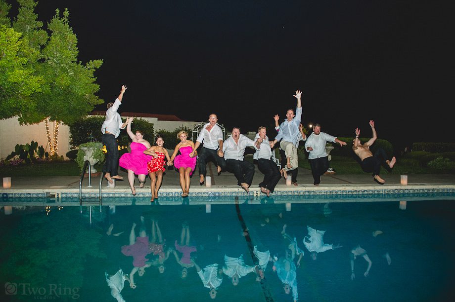 Bridal party jumping in pool