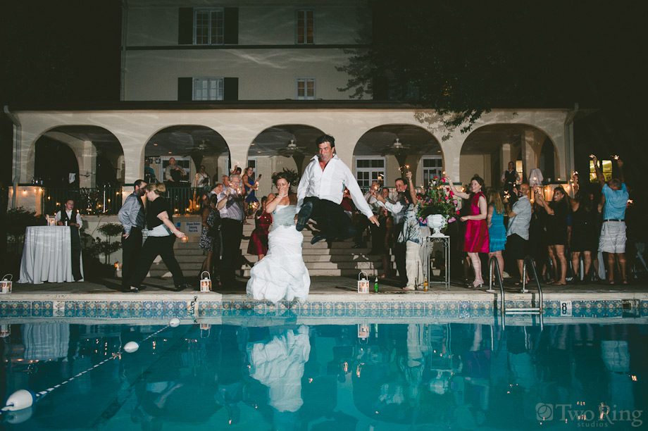 Bride and groom jump in pool